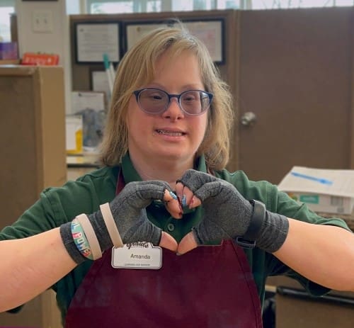 Amanda making a heart shape with her hands